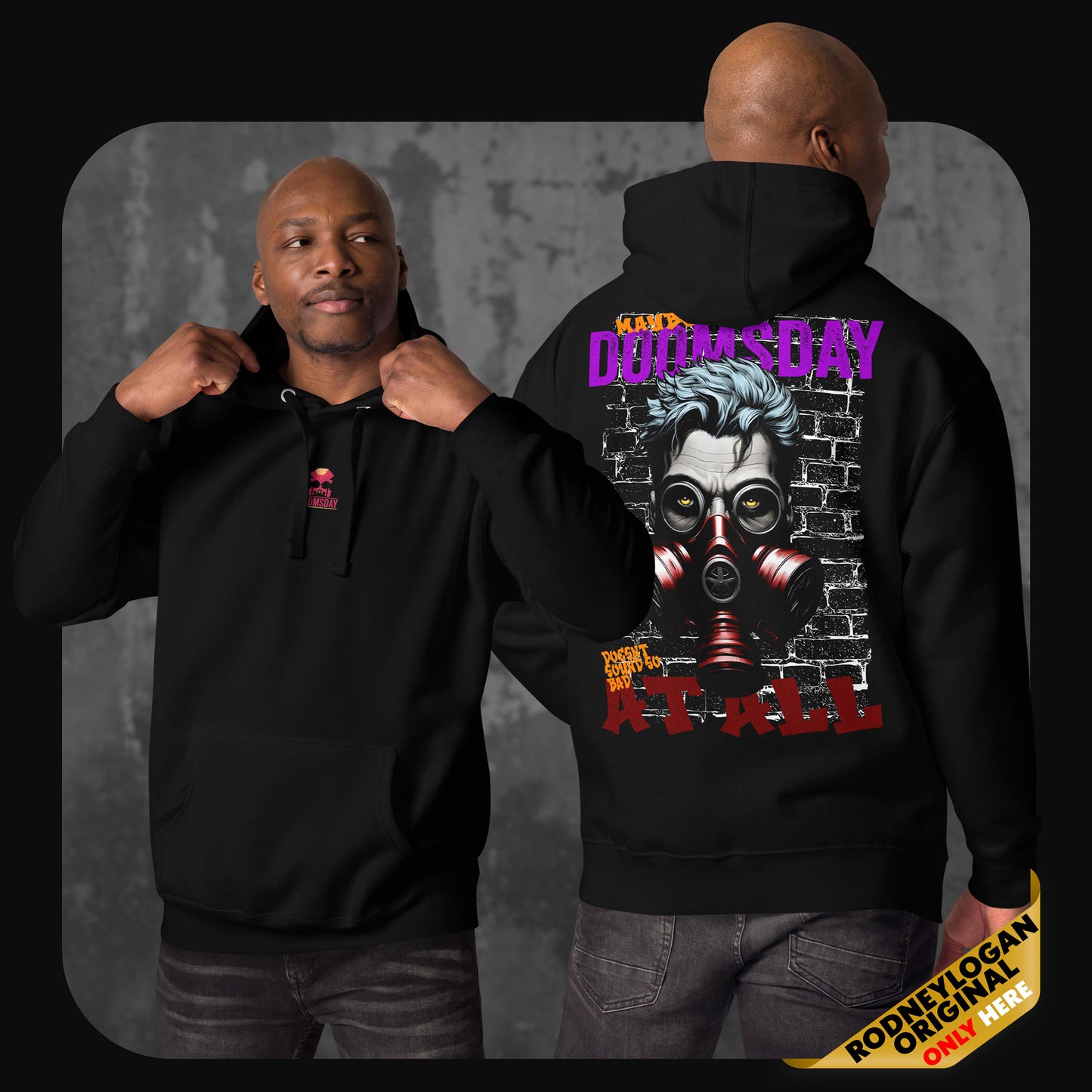 A man models a black hoodie with a red skull and text logo on the front chest and a large graphic on the back showing a man with blue hair wearing a red gas mask in front of a brick wall.