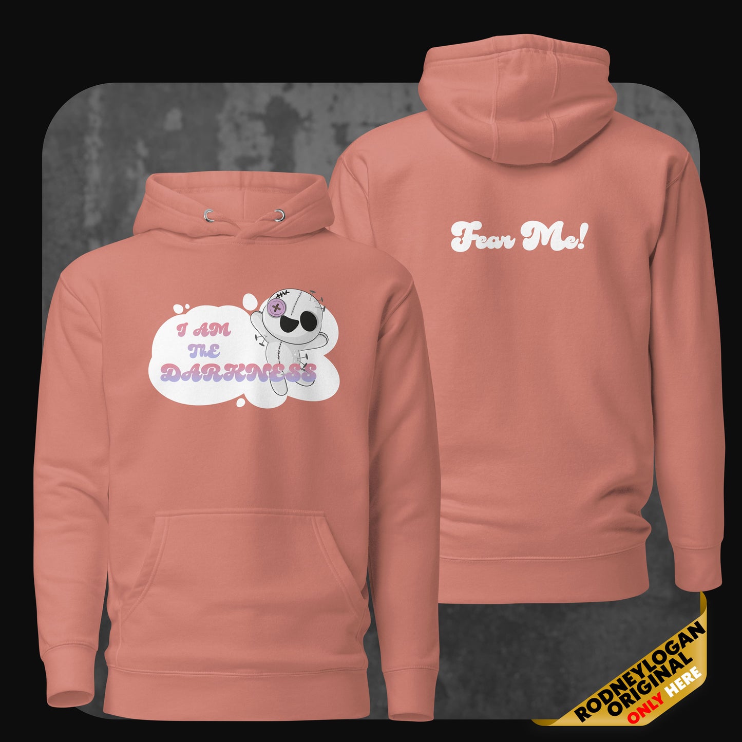 Front and back view of a dusty rose-colored hoodie showing the plush character design with pastel typography and a “Fear Me!” slogan in white on the back.