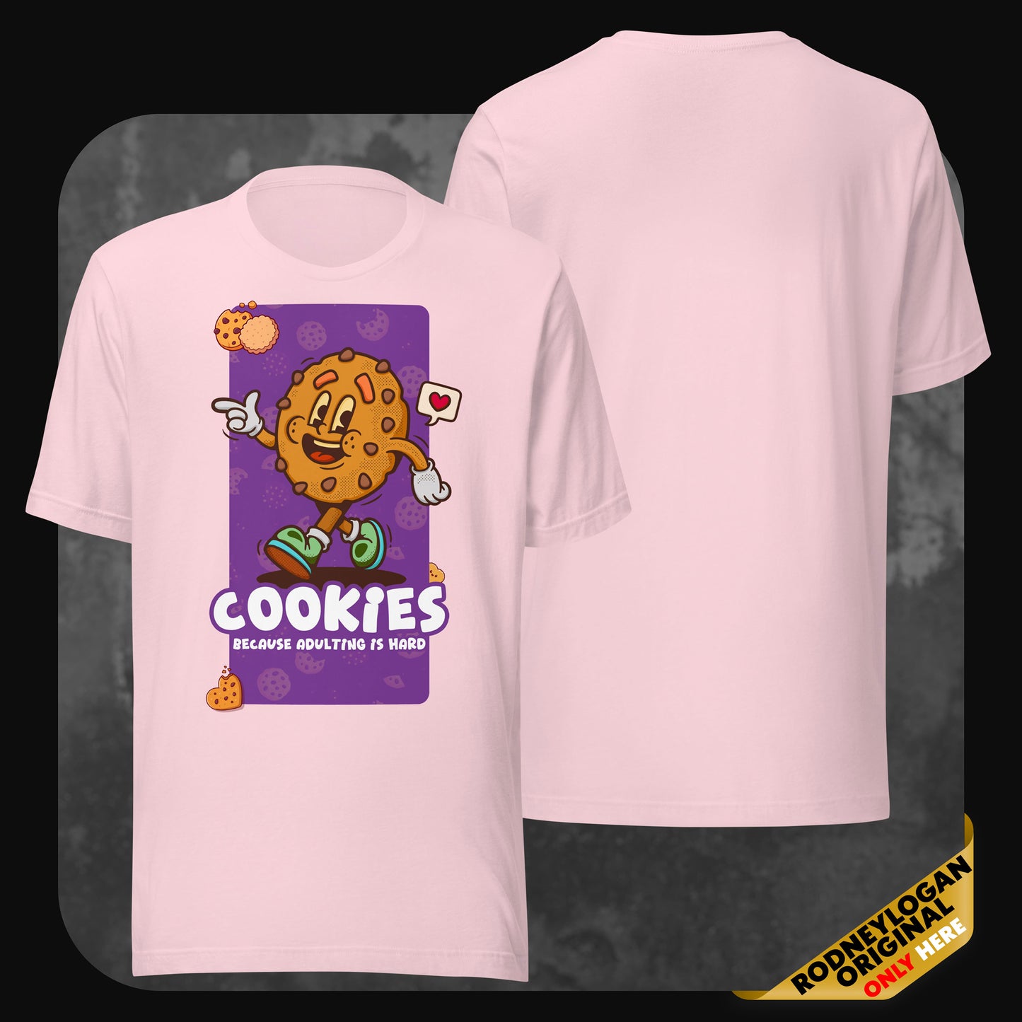 Pastel pink t-shirt displaying a playful chocolate chip cookie with arms, sneakers, and a cheerful face. Below, the phrase “Cookies – Because adulting is hard.”