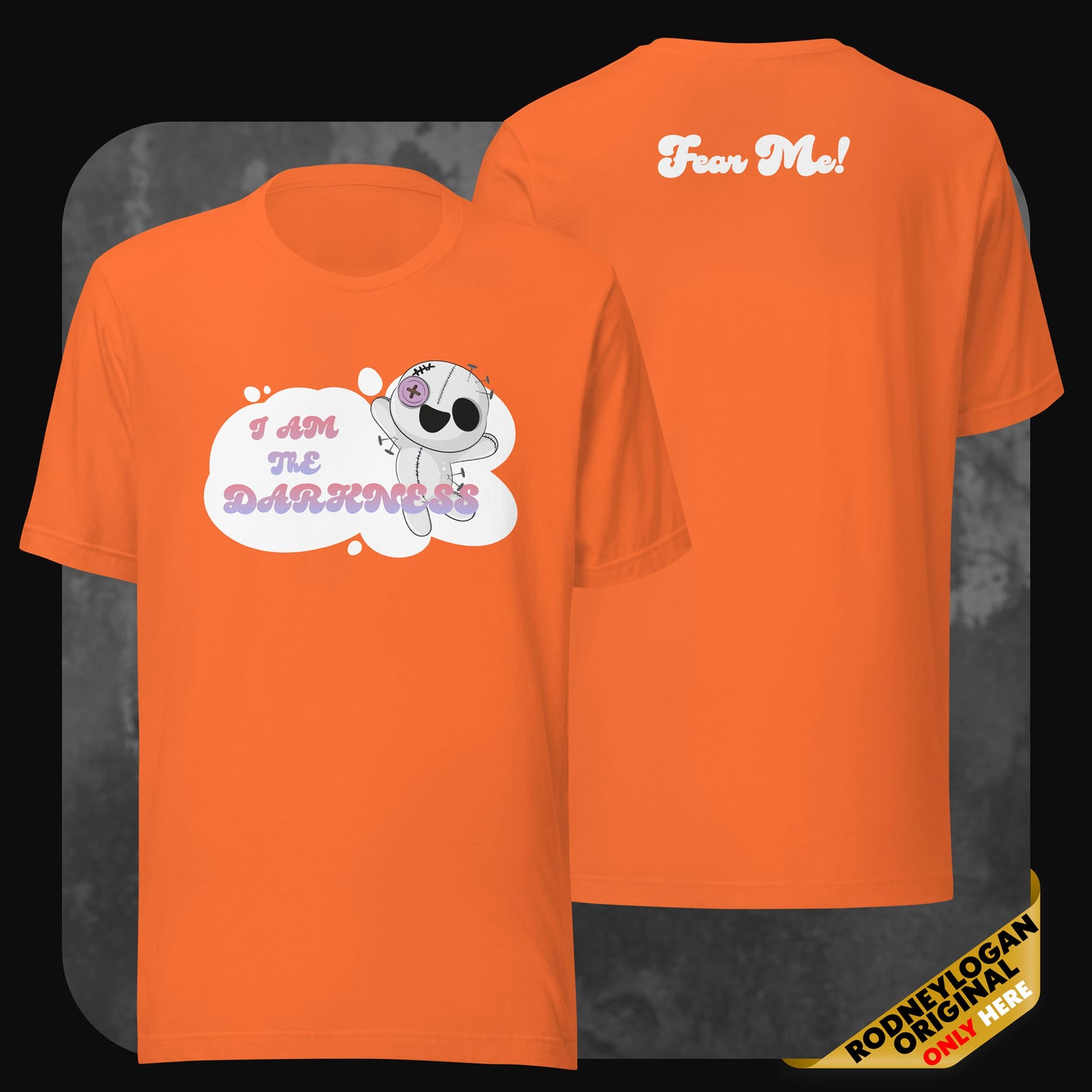 Front and back view of an orange t-shirt showing the same dark-cute design with the stitched character and phrases in pastel shades.
