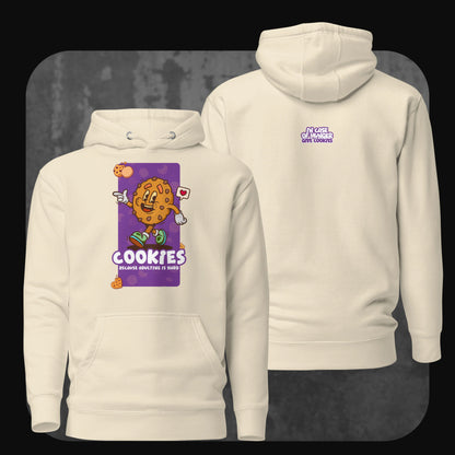 A bone-colored hoodie featuring a cheerful cartoon cookie holding a heart sign, with the text “Cookies because adulting is hard” on the front. The back includes the playful phrase “In case of hunger, give cookies” in purple.