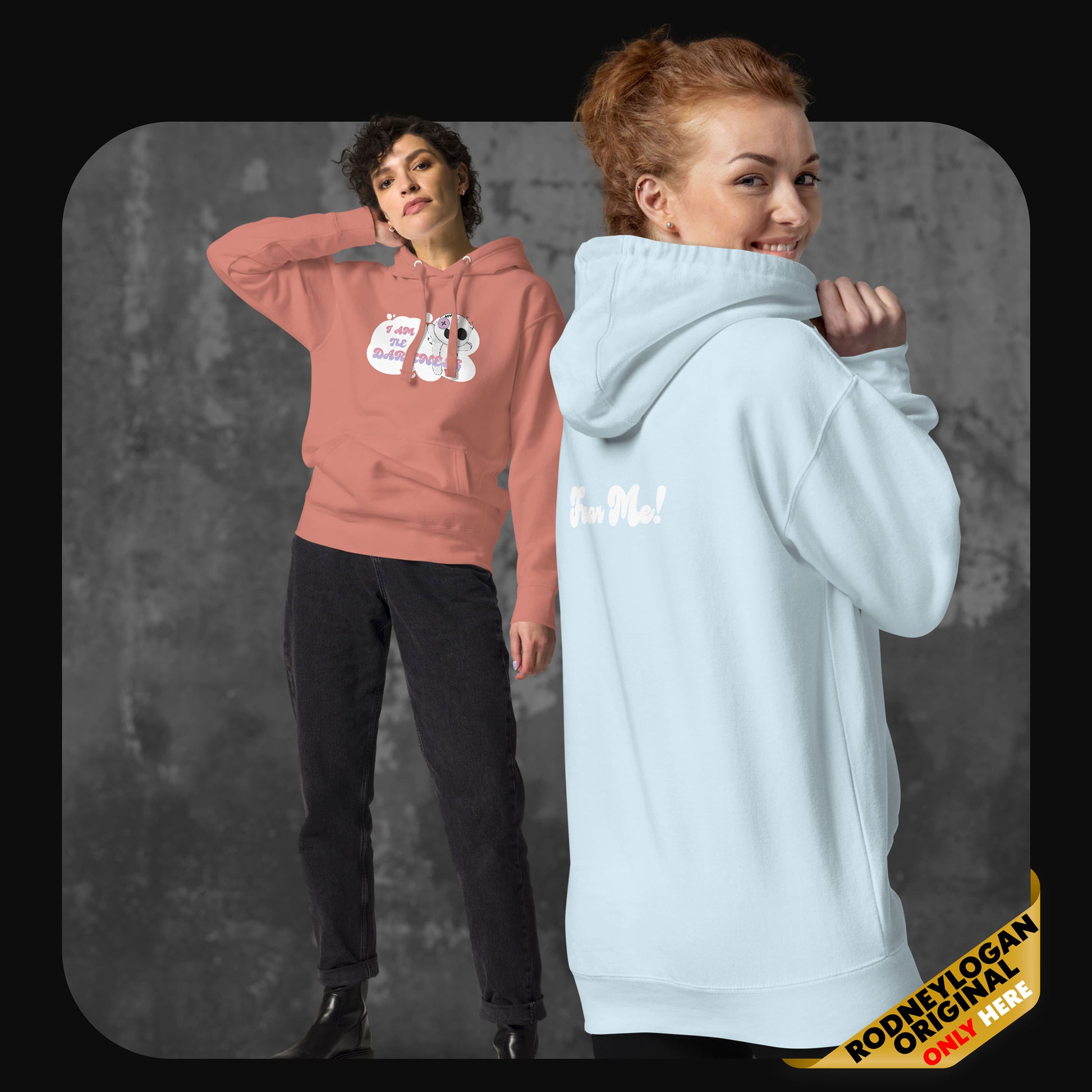 Two models wearing the hoodie in dusty rose and sky blue; one facing forward with the front design, the other turned to show the back “Fear Me!” print.