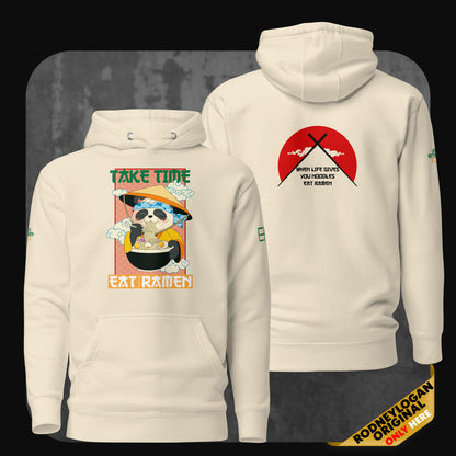 Front and back view of a bone-colored hoodie featuring a sloth eating ramen with the text “Take Time Eat Ramen” on the front and chopsticks over a red circle with the phrase “When life gives you noodles, eat ramen” on the back.