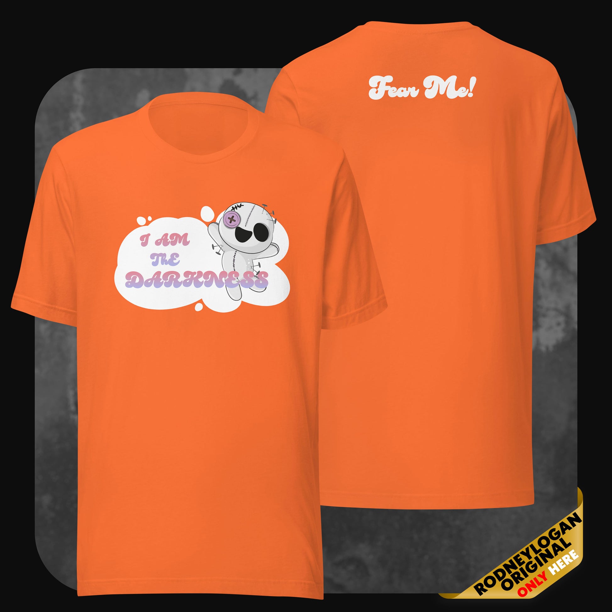 Front and back view of an orange t-shirt showing the same dark-cute design with the stitched character and phrases in pastel shades.