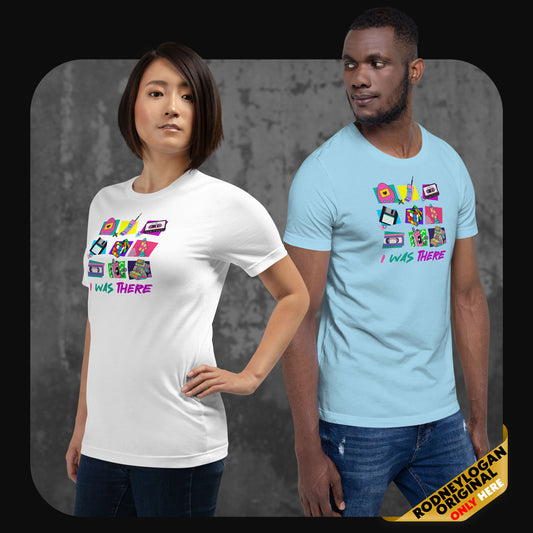 A woman in a white shirt and a man in a sky-blue shirt, both wearing “I WAS THERE” t-shirts showcasing vibrant retro tech illustrations and bold neon text.