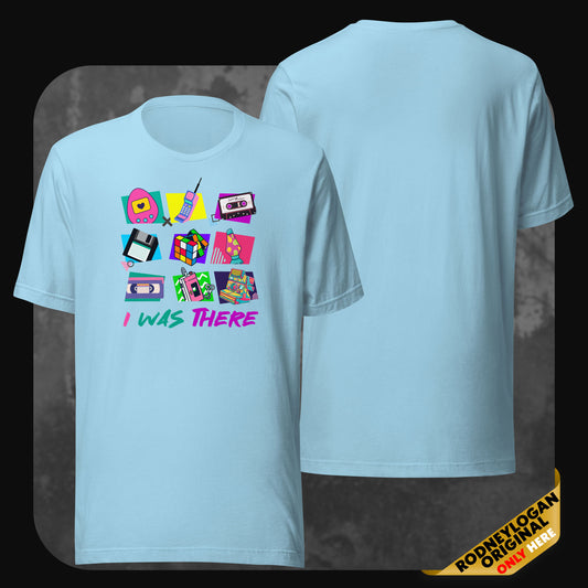 Sky-blue t-shirt with a front graphic of vintage technology and pop culture items in bright neon colors, captioned with “I WAS THERE”.