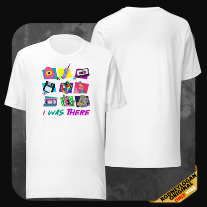 White t-shirt featuring colorful retro icons like a pager, floppy disk, Rubik’s cube, cassette tape, and VHS, with the text “I WAS THERE” in a bold ’90s-style font.